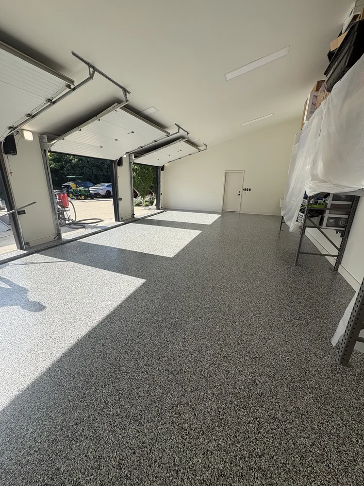 Epoxy-coated garage floor with flake finish in a two-car garage